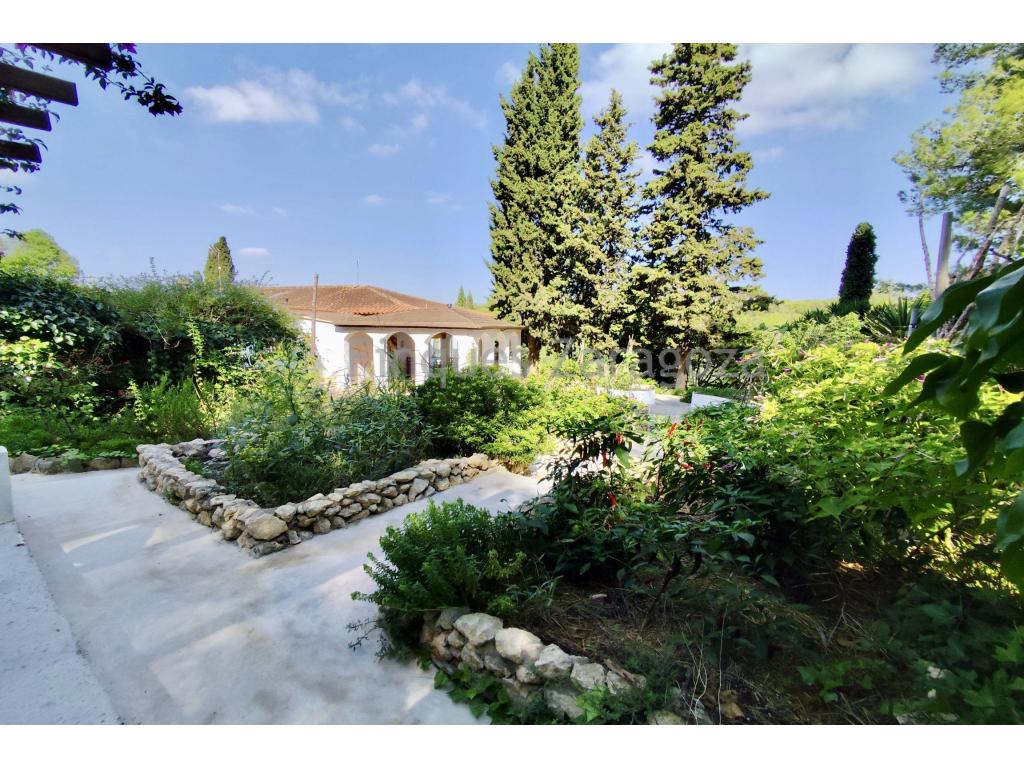 Finques Zaragoza is delighted to present Font d’Horta, a unique blend of rustic tradition and modern creativity. Lovingly renovated by its current owners and transformed into a contemporary, artistic retreat, this exceptional terraced house offers both a warm family home and endless possibilities thanks to its spacious ground-floor workshop.Perfectly located, Font d’Horta combines rural tranquillity with unbeatable convenience. Just a short walk from the charming village of L’Arboç, with its schools, shops and essential services, and a brief journey from vibrant Barcelona, it is an ideal setting for families seeking a connected yet peaceful lifestyle. The beautiful beaches of the Garraf coast are also only a few kilometres away.The property extends over more than 8,000 m² of private land, accessed via a discreet track that leads into a world of gardens, woodland and orchards. The thoughtfully designed garden surrounds the house with a series of charming terraces and outdoor dining areas, including a barbecue corner and panoramic views over the surrounding forest. The land is as practical as it is beautiful, featuring a fenced meadow ready for cultivation, a chicken coop, an auxiliary building, and paths winding through the woodland down to two levels of olive groves with approximately 60 mature olive trees, as well as a selection of fruit trees.Font d’Horta is fully connected to the mains electricity supply and benefits from shared well water, ensuring modern comfort without compromise. With 261 m² of built area, the house is terraced on the first floor, offering privacy alongside the reassurance of nearby neighbours. A shaded entrance leads to a generous parking area and the versatile ground-floor workshop, currently used as an art studio but easily adaptable to any project. This level also includes a handcrafted kitchen, two bedrooms, a bathroom and a storage room. Carefully restored, the house celebrates its rustic character with original floors, traditional design features, renovated kitchens and bathrooms, and the peace of mind of a fully updated electrical system.The first floor is designed to maximise light and views, featuring a spacious living room overlooking the countryside, a beautifully restored bathroom, a double bedroom and a rustic-style kitchen that opens directly onto a covered terrace. This terrace is one of the property’s highlights: a serene retreat with panoramic views over the gardens and forest, perfect for relaxing or entertaining guests. With two independent floors, the layout also offers the flexibility to create separate living spaces if desired.Font d’Horta is much more than a property; it is a creative sanctuary, a family home and a little piece of paradise in the Catalan countryside—all just a stone’s throw from Barcelona.